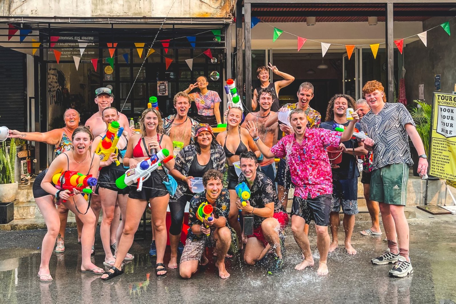 Islander guests with water guns celebrating Songkran outside the hostel